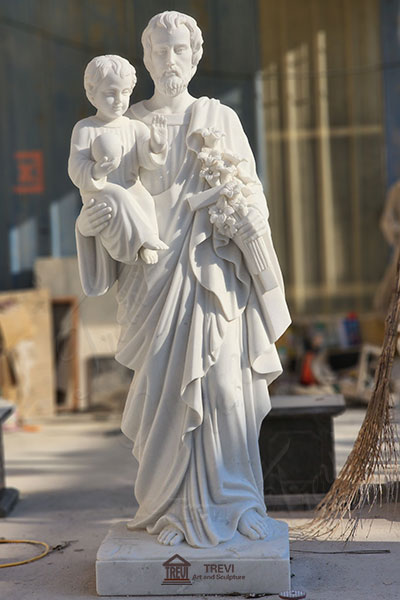 saint joseph holding jesus statue